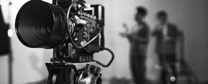 Close-up of professional camera for professional shooting with camera crew in background